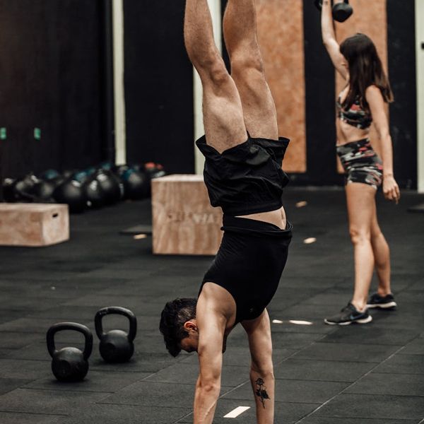 Focused man during a complex bodyweight exercise, showing strength and balance.